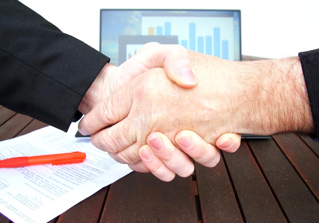 Partnership handshake between two executives